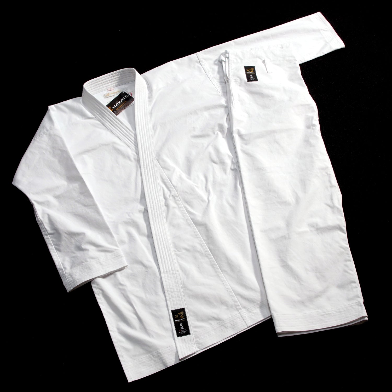 Hayate white martial arts gi on a black background
