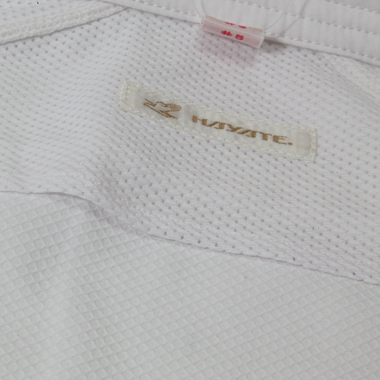 Close-up of a textured fabric surface with a 'KAYATE' label.