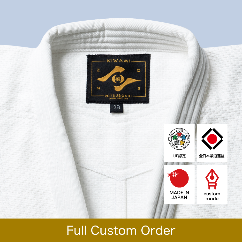 White judo jacket with a Zone logo on a light blue background