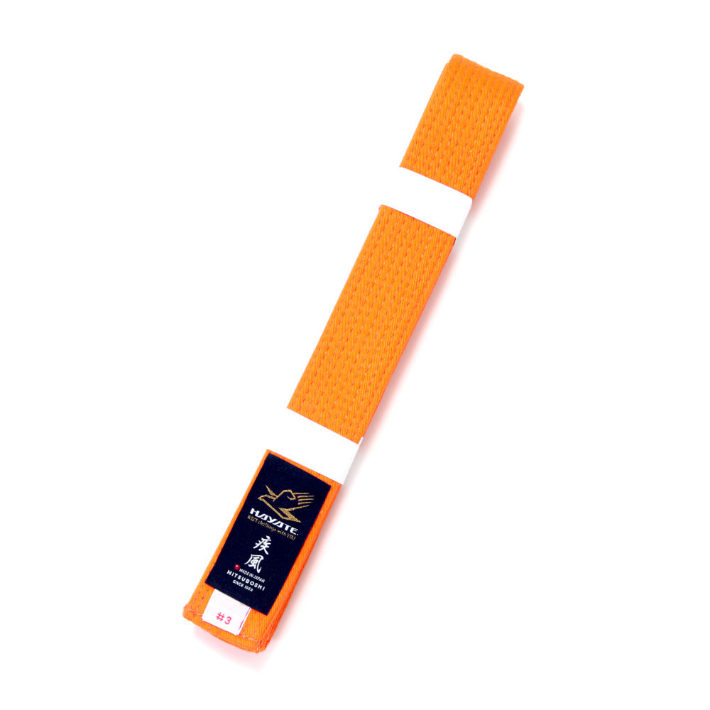 Orange martial arts belt with a Hayate brand label on a white background