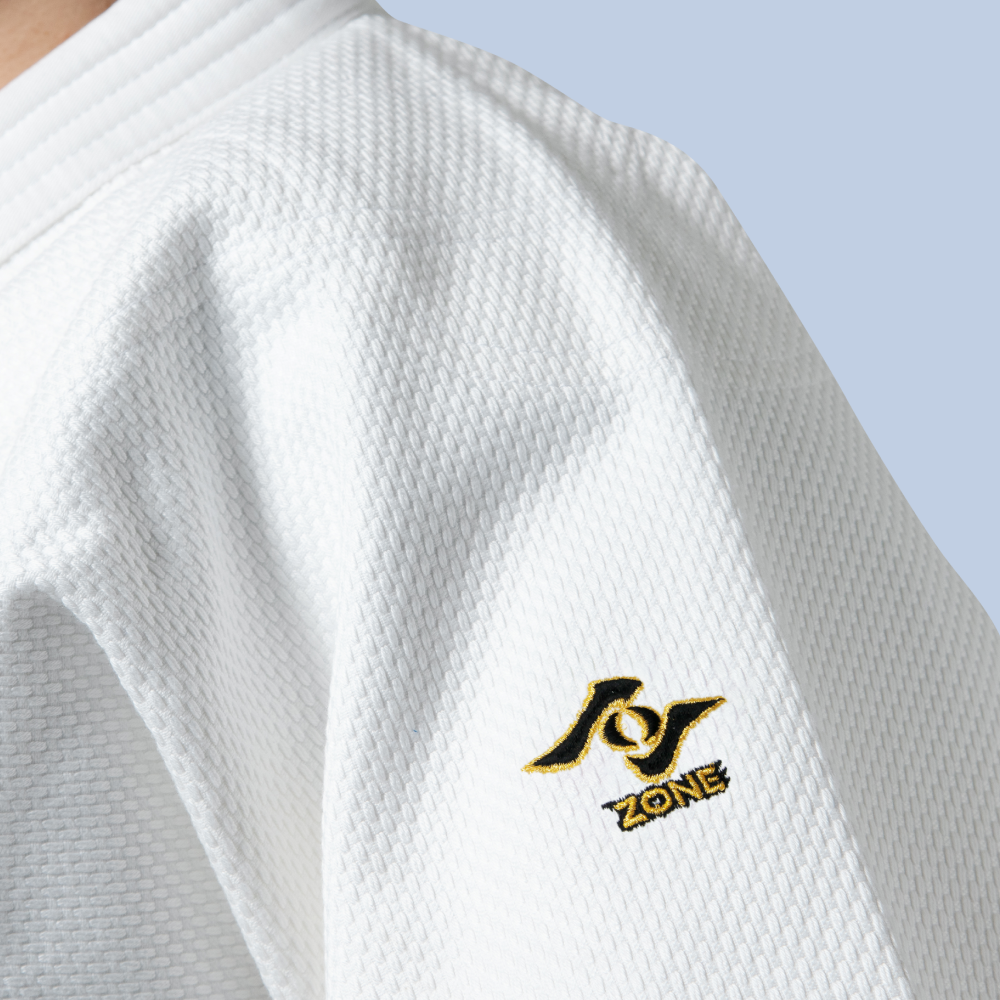 White kiwami judo jacket with the Zone logo on a light blue background