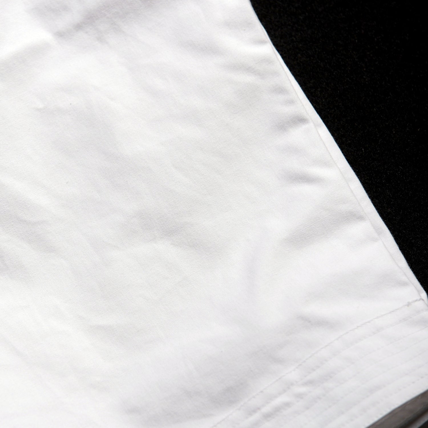 Close-up of a white fabric with a black border