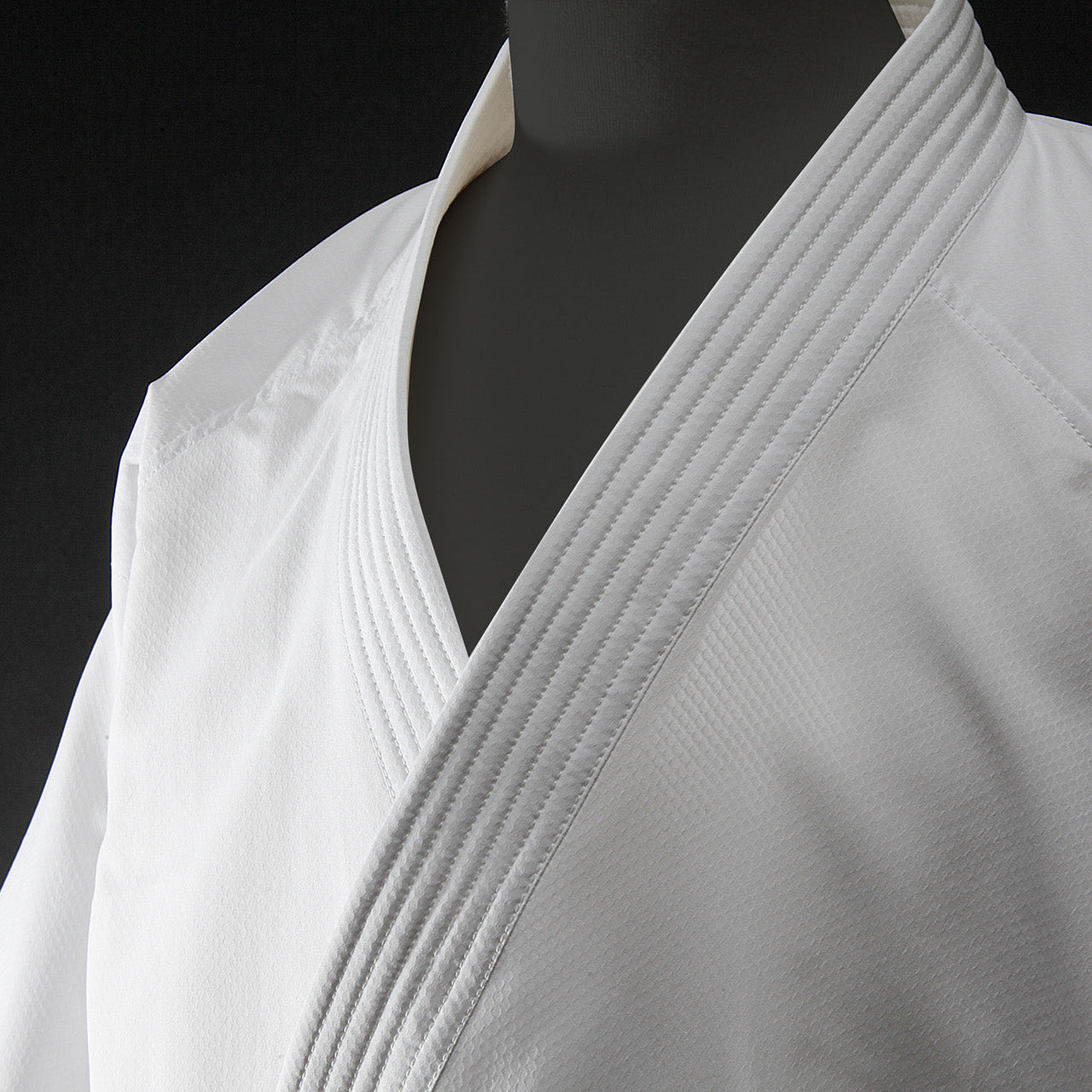 Hayate white martial arts gi on a black background