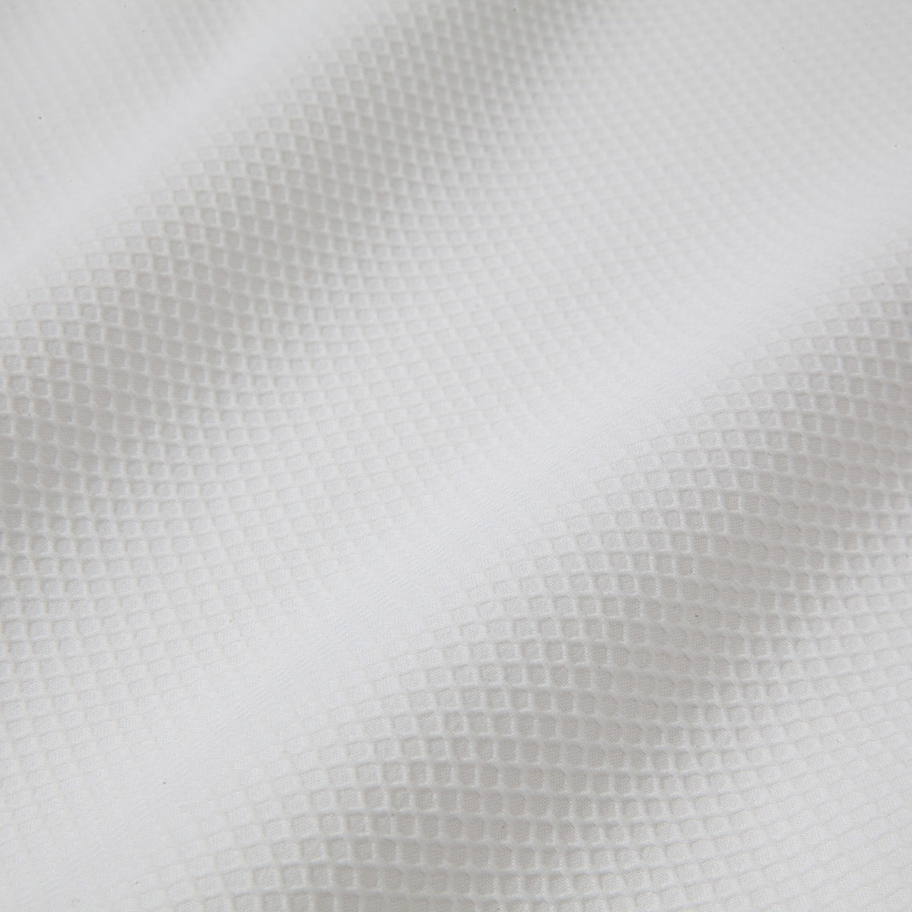 Close-up of a textured white fabric surface
