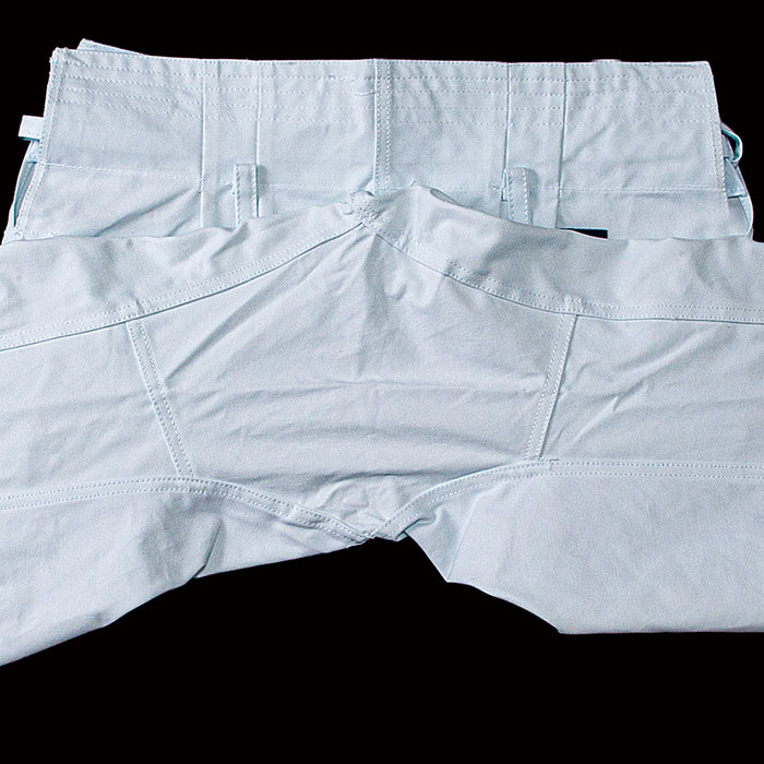 Light blue pants laid flat on a black background